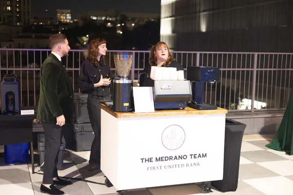 The Medrano Team coffee cart on the rooftop with the Austin skyline behind
